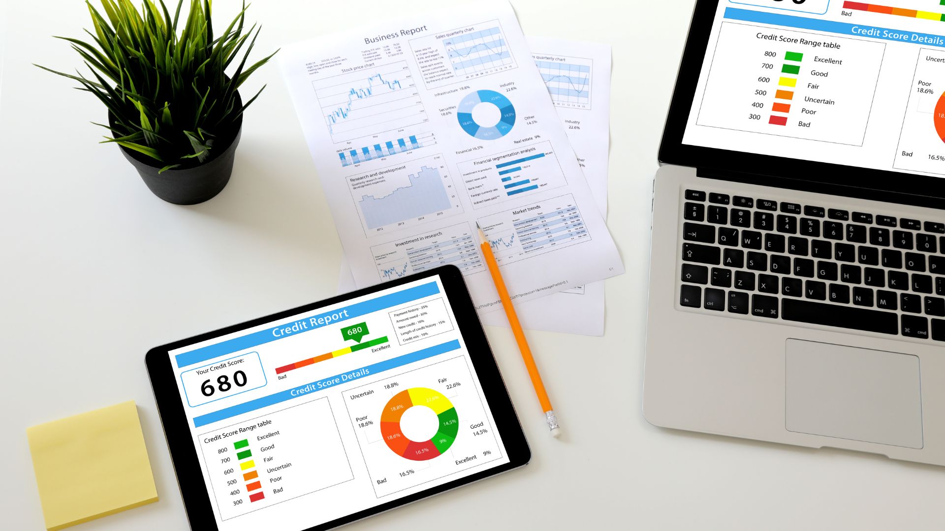Website%20Dev.%20-%202025-05-30T163217.057 tablet, paper, and laptop being used for calculations and financial planning